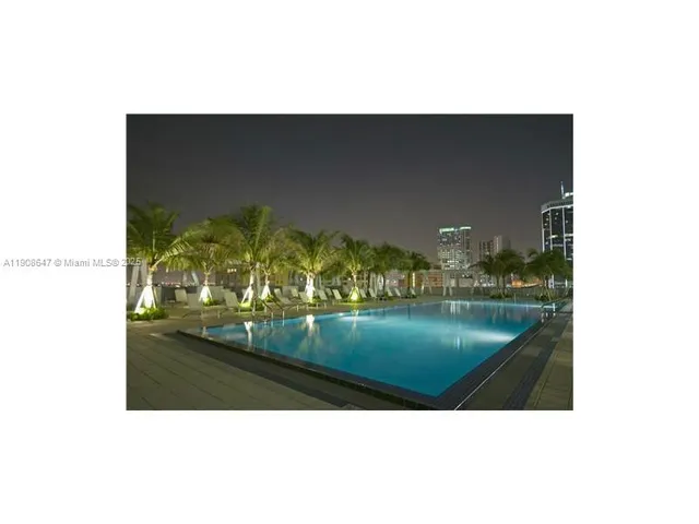 a swimming pool view with a outdoor seating space