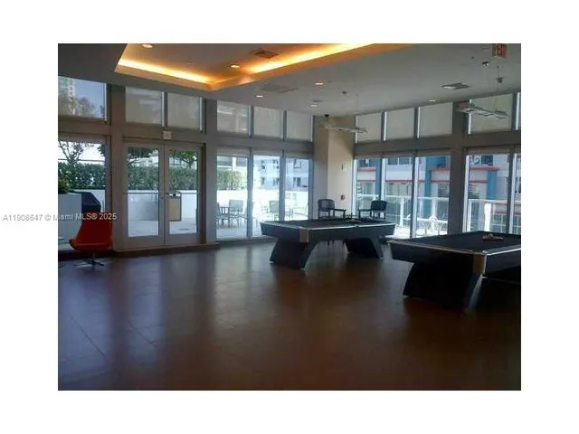 a living room with patio furniture and a large window