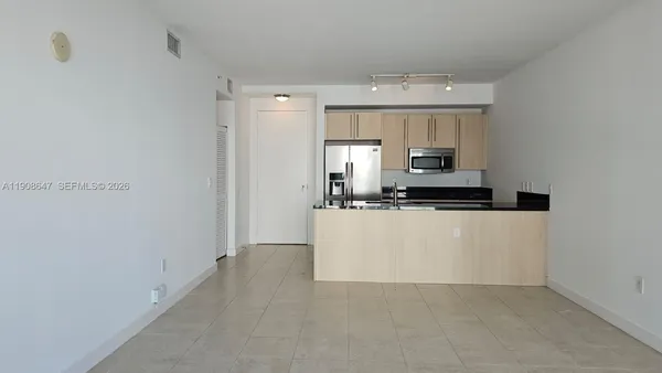 a view of kitchen cabinets and stainless steel appliances