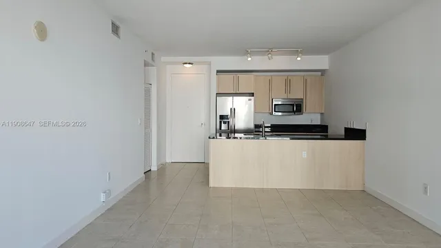 a view of kitchen cabinets and stainless steel appliances