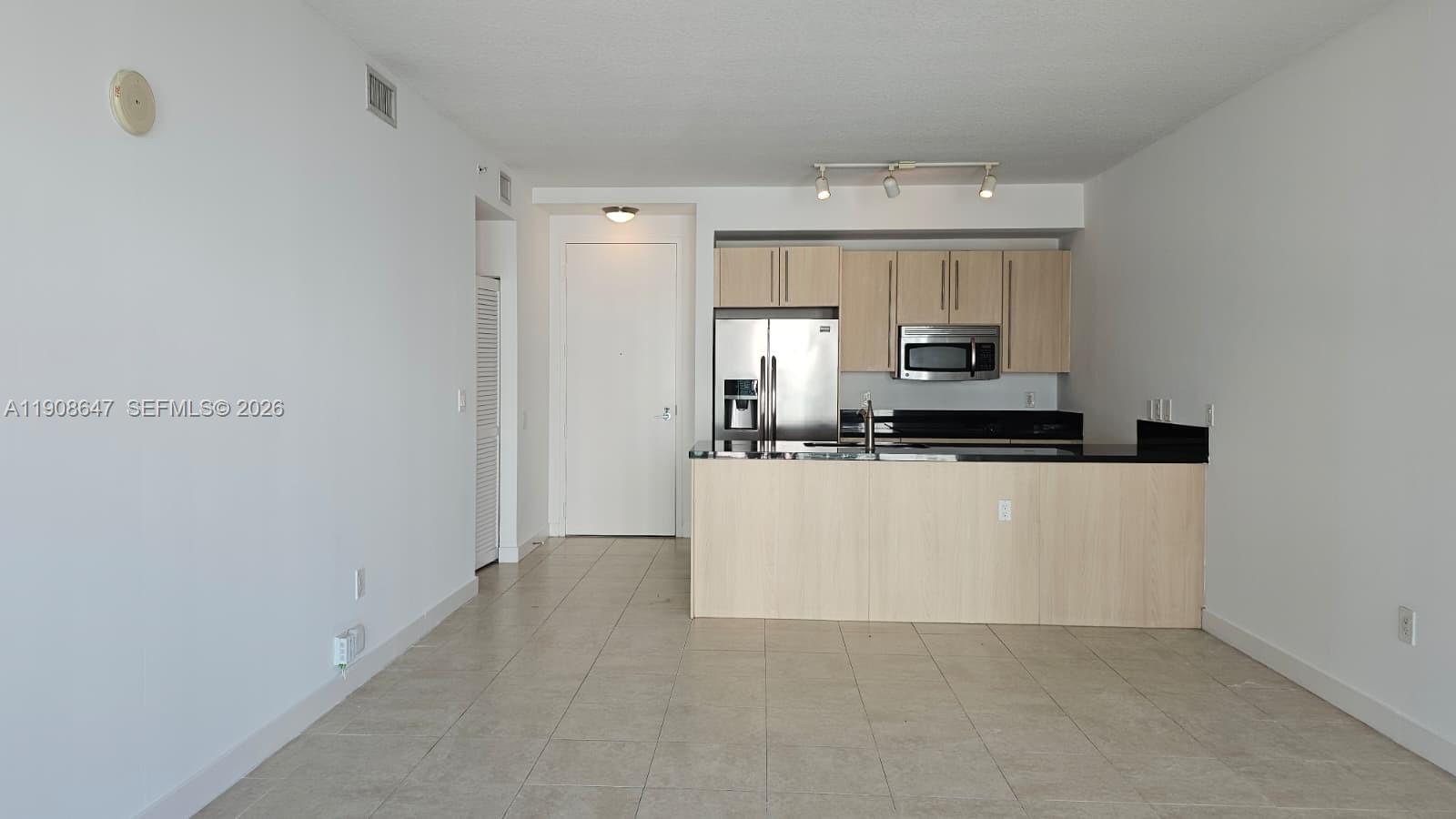 1111 Southwest 1st Avenue, Unit 2124N Miami, FL 33130 - Photo 2 of 34 a view of kitchen cabinets and stainless steel appliances