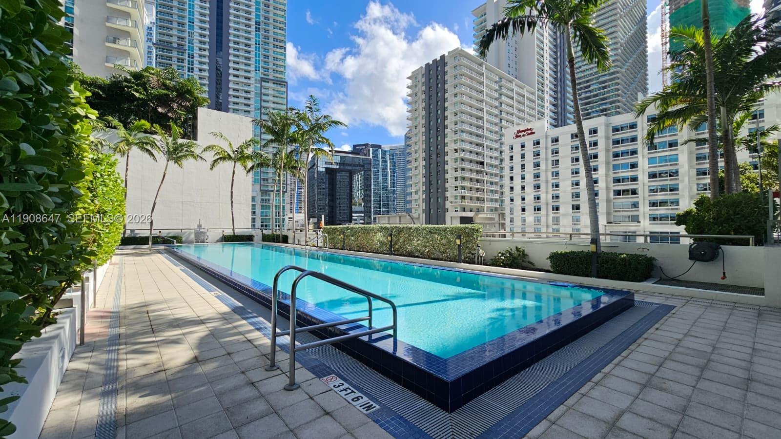 1111 Southwest 1st Avenue, Unit 2124N Miami, FL 33130 - Photo 22 of 34 a view of a swimming pool with a lounge chairs