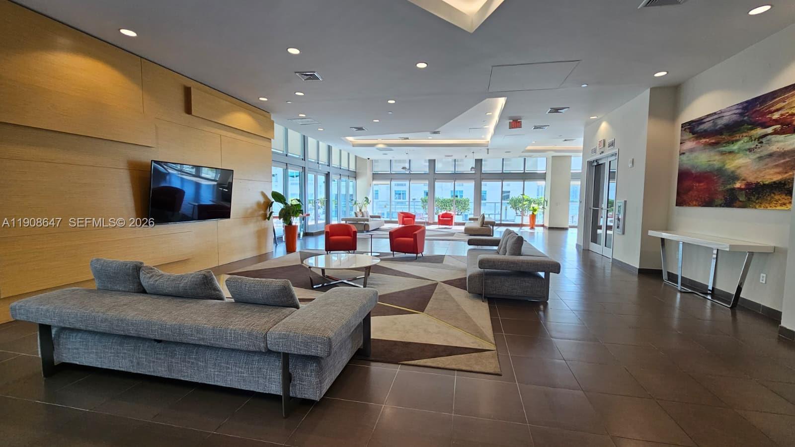 1111 Southwest 1st Avenue, Unit 2124N Miami, FL 33130 - Photo 23 of 34 a living room with furniture and a flat screen tv