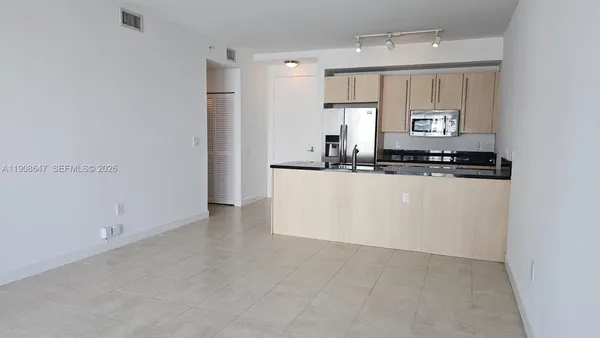 a kitchen with stainless steel appliances a sink stove and cabinets