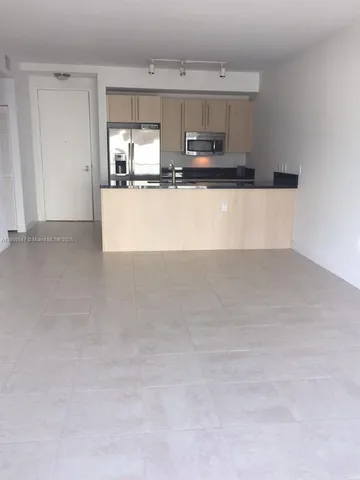 a view of a kitchen with microwave and cabinets