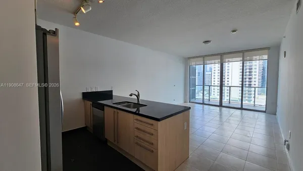 a kitchen with stainless steel appliances granite countertop a sink and a cabinets