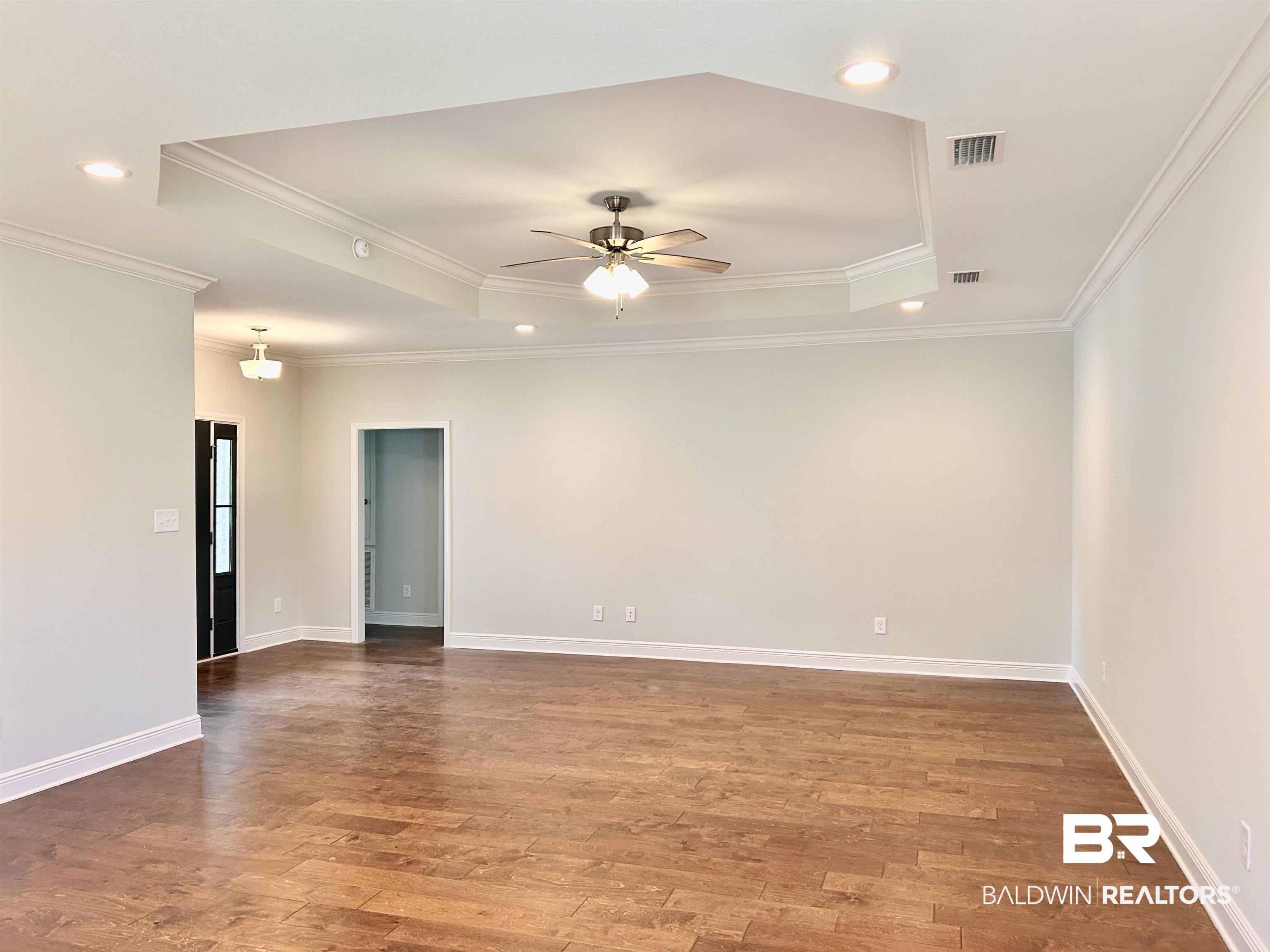 1267 Pembroke Way Foley, AL 36535 - Photo 4 of 17 Unfurnished room with ornamental molding, hardwood / wood-style flooring, and ceiling fan