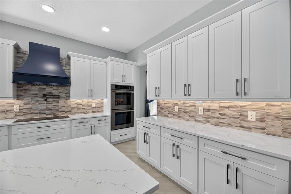 4310 70th Avenue East Ellenton, FL 34222 - Photo 13 of 97 a kitchen with white cabinets sink and stainless steel appliances