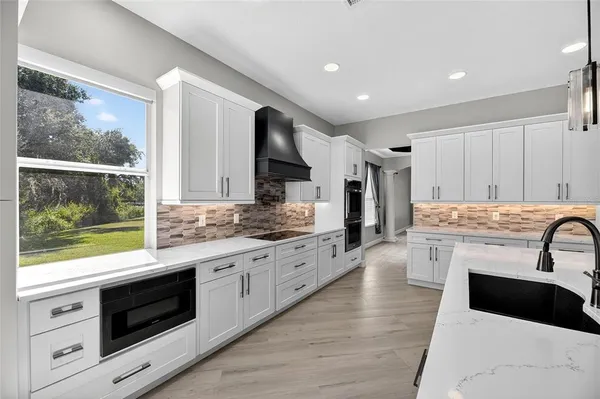 a view of a hallway with wooden floor and closet