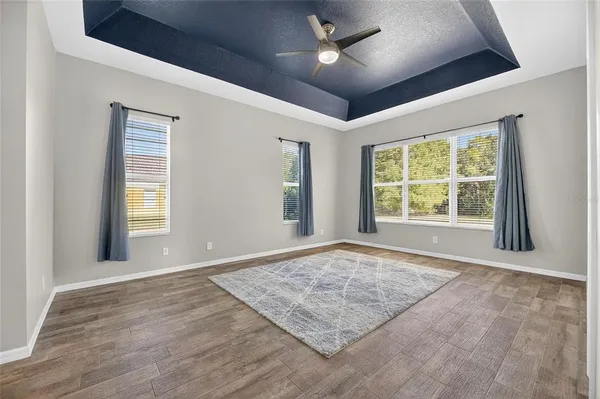 a spacious bedroom with a bed and window