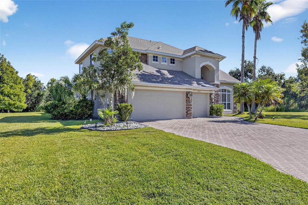 4310 70th Avenue East Ellenton, FL 34222 - Photo 2 of 97 a front view of a house with a yard and palm trees