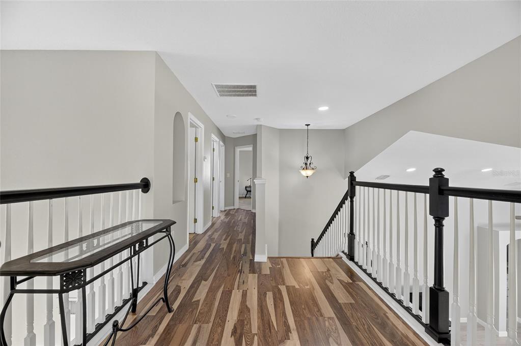 4310 70th Avenue East Ellenton, FL 34222 - Photo 21 of 97 a view of a hallway with wooden floor and staircase