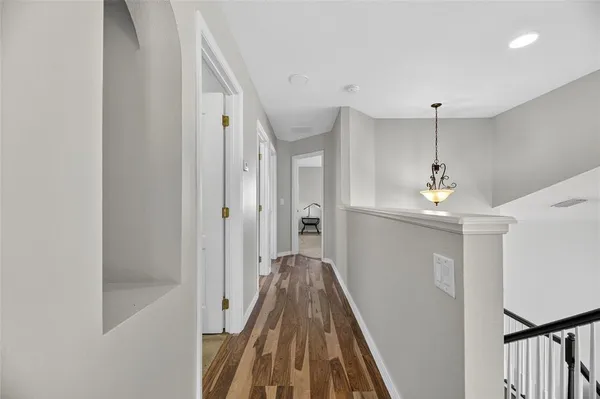 a white toilet sitting next to a white wall