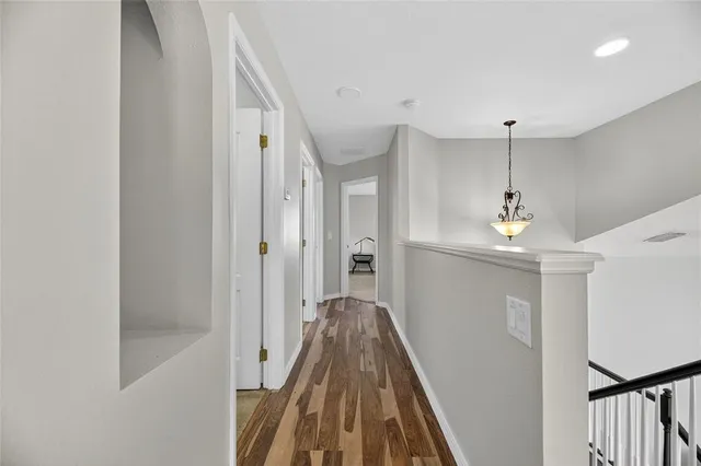 a white toilet sitting next to a white wall