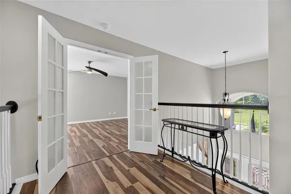 a view of a hallway with wooden shelves