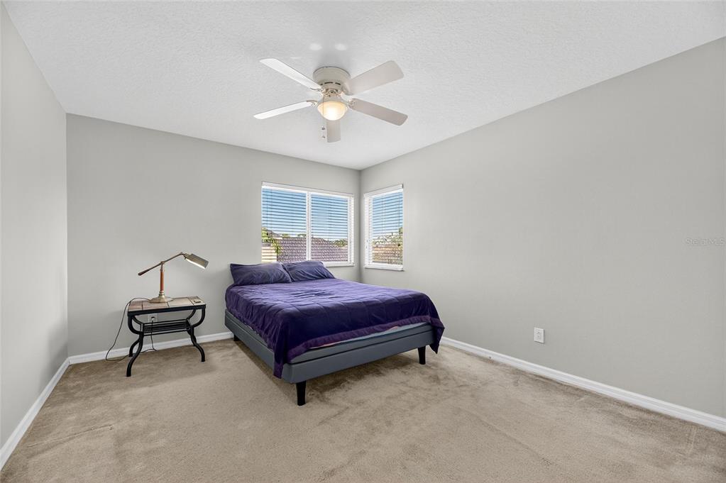 4310 70th Avenue East Ellenton, FL 34222 - Photo 33 of 97 a spacious bedroom with a bed and window