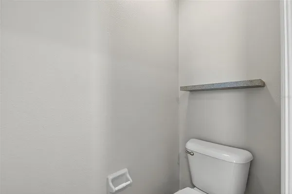 a bathroom with a sink mirror and toilet
