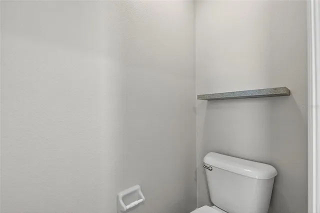 a bathroom with a sink mirror and toilet