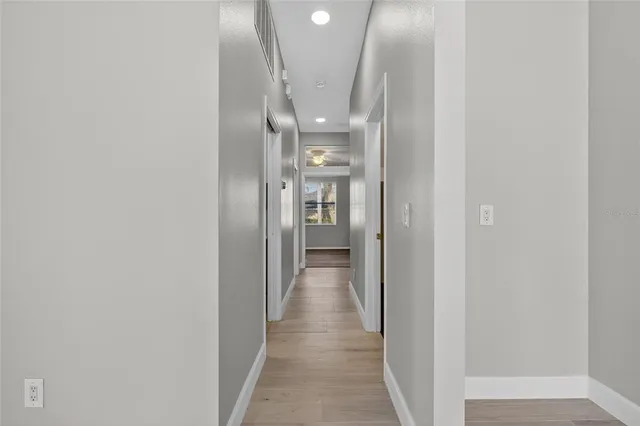 a view of a house with a big yard and potted plants