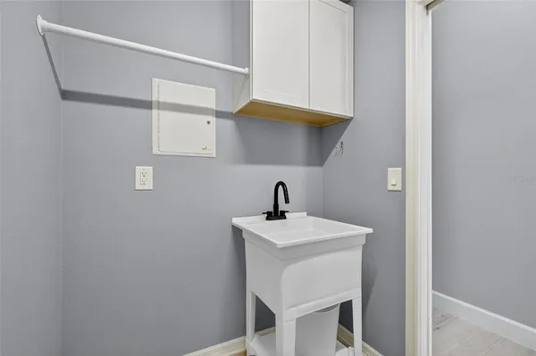 an aerial view of a house with a yard and lake view in back