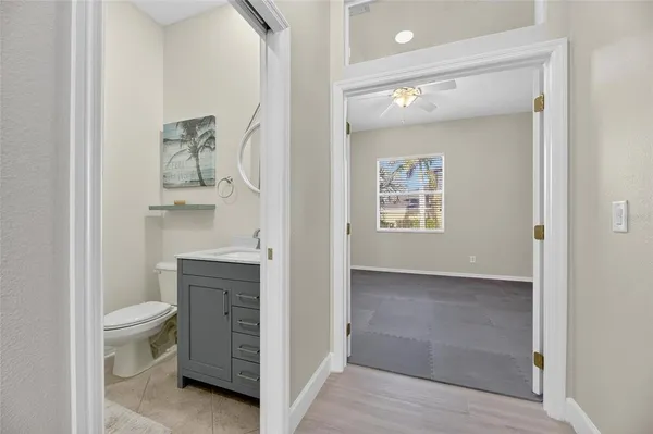 an aerial view of residential houses with outdoor space and trees