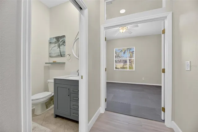 an aerial view of residential houses with outdoor space and trees