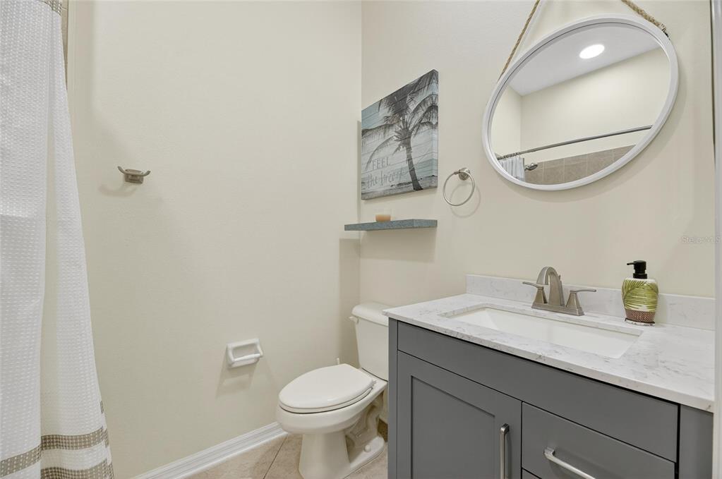 4310 70th Avenue East Ellenton, FL 34222 - Photo 48 of 97 a bathroom with a toilet a sink a mirror and vanity