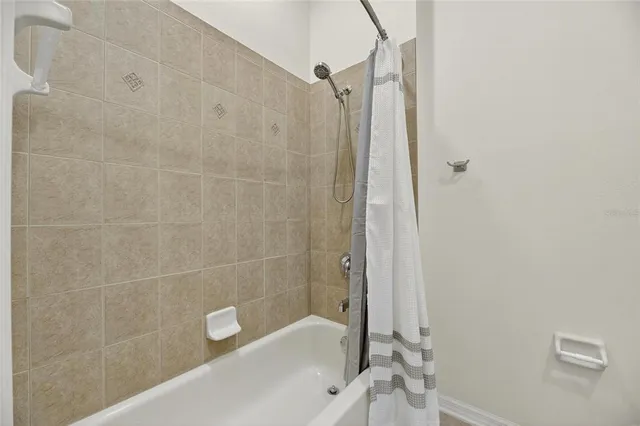 an aerial view of a house with a yard and lake view