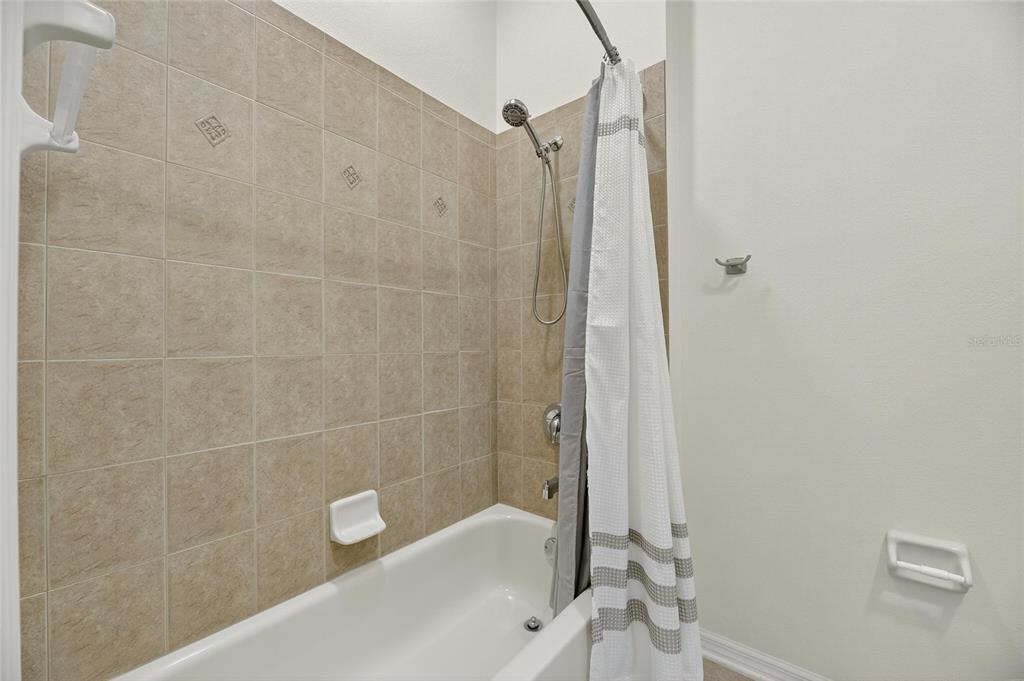 4310 70th Avenue East Ellenton, FL 34222 - Photo 49 of 97 a bathroom with a bathtub and a shower