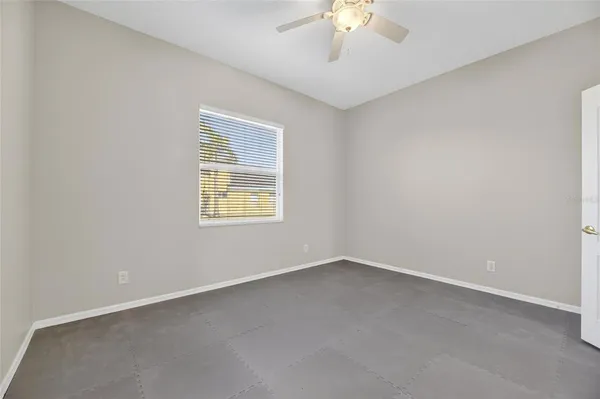 an aerial view of a house with a yard and trees