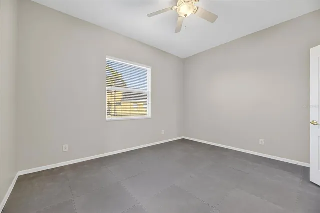 an aerial view of a house with a yard and trees