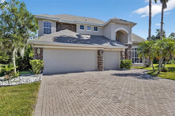 a kitchen with white cabinets sink and stainless steel appliances