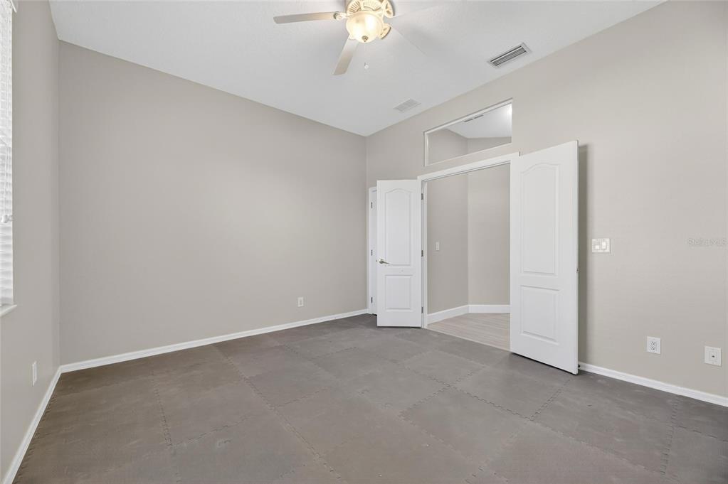 4310 70th Avenue East Ellenton, FL 34222 - Photo 51 of 97 a view of an empty room with a chandelier fan
