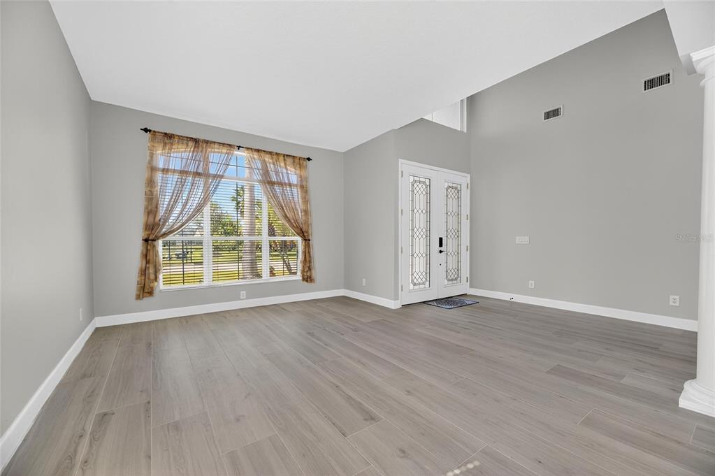 4310 70th Avenue East Ellenton, FL 34222 - Photo 59 of 97 a view of an empty room with wooden floor and windows