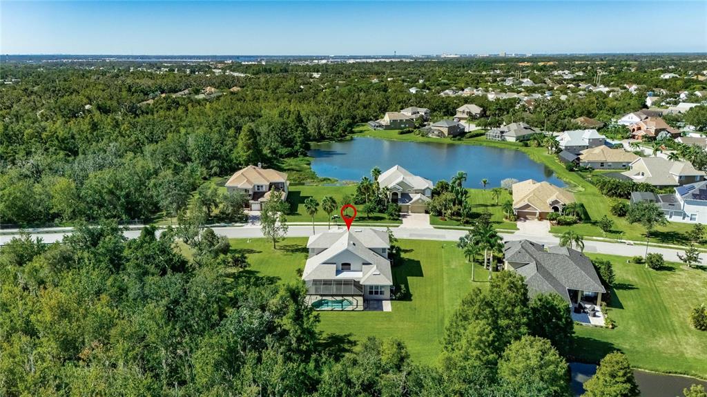 4310 70th Avenue East Ellenton, FL 34222 - Photo 94 of 97 an aerial view of a houses with a yard and lake view