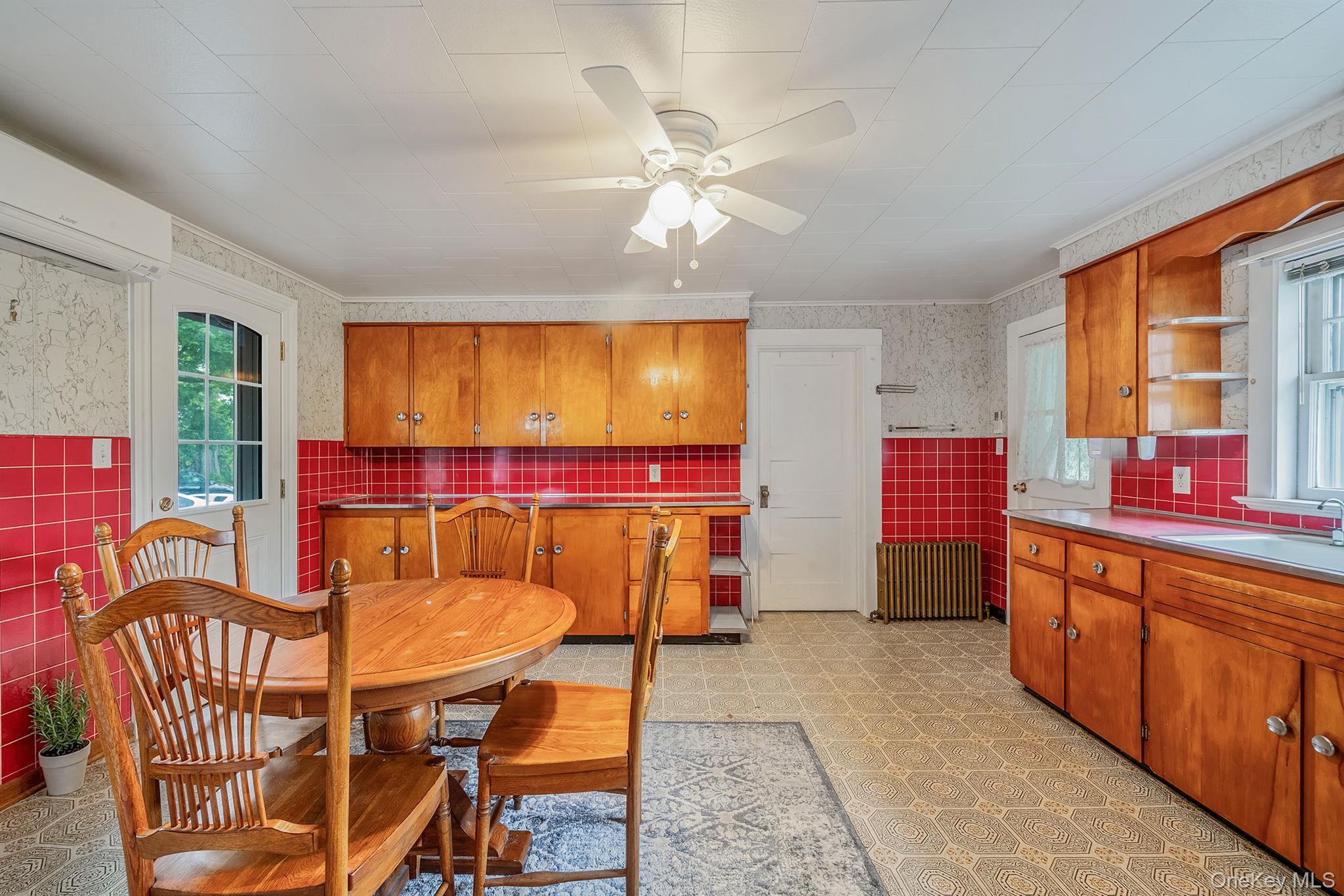 1055 Oregon Road Mattituck, NY 11952 - Photo 9 of 33 Country Kitchen with an abundance of Cabinetry, Counter Space and spacious area for able and Chairs.