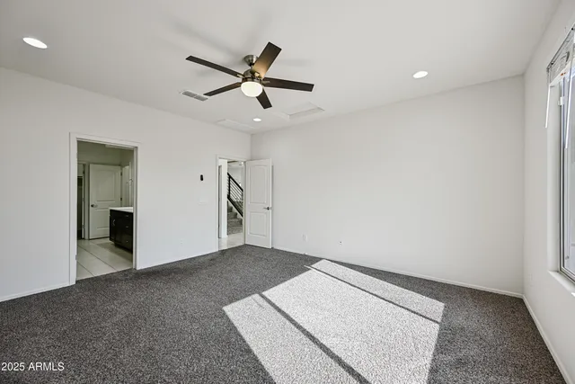 an empty room with closet and windows