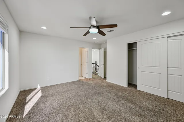 a view of a livingroom with a ceiling fan and window