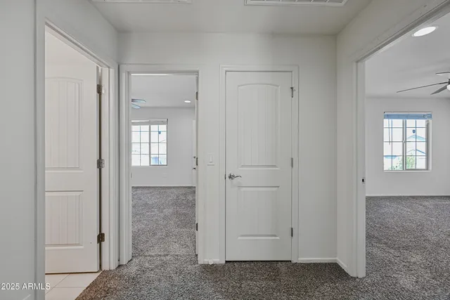 an empty room with windows and closet