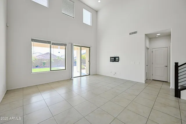 an empty room with windows and closet