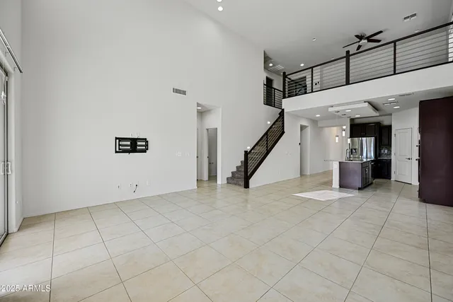 a view of a livingroom with stairs and furniture