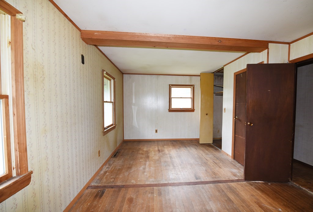 7 Gates Road Marshfield, MA 02050 - Photo 19 of 37 a view of an empty room with wooden floor and a window