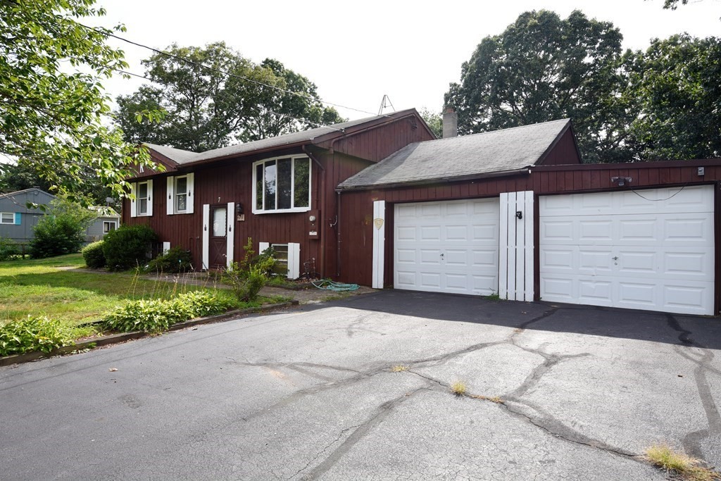 7 Gates Road Marshfield, MA 02050 - Photo 2 of 37 a front view of a house with a yard and garage