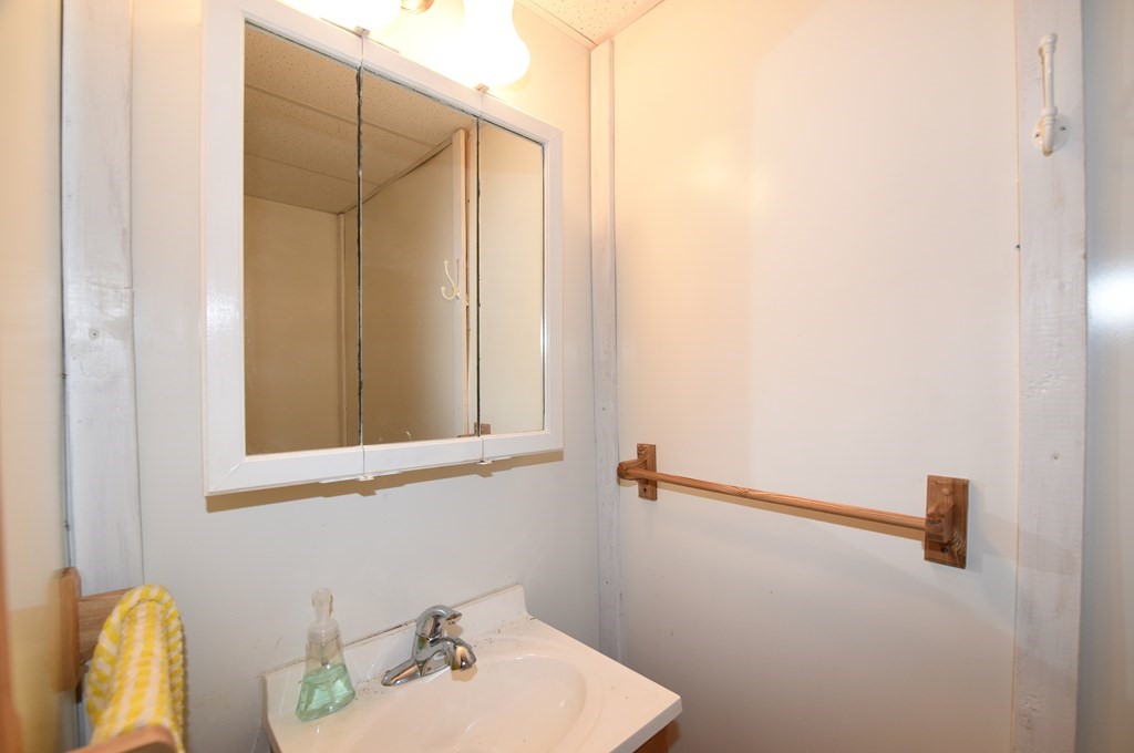 7 Gates Road Marshfield, MA 02050 - Photo 31 of 37 a bathroom with a sink and a mirror