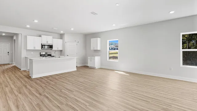 a view of kitchen with granite countertop cabinets and wooden floor