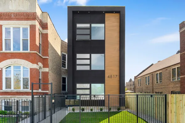a view of a brick house with a small yard
