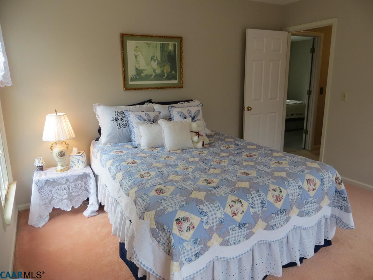 315 Grassmere Road Charlottesville, VA 22903 - Photo 17 of 32 a bedroom with a bed and a lamp on dresser