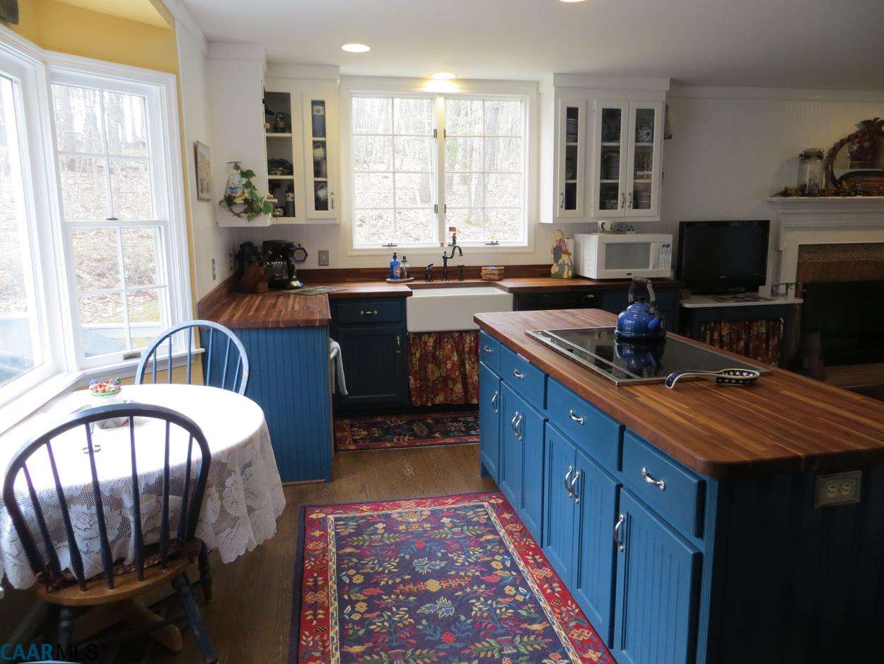 315 Grassmere Road Charlottesville, VA 22903 - Photo 8 of 32 a kitchen with stainless steel appliances granite countertop a sink stove and cabinets