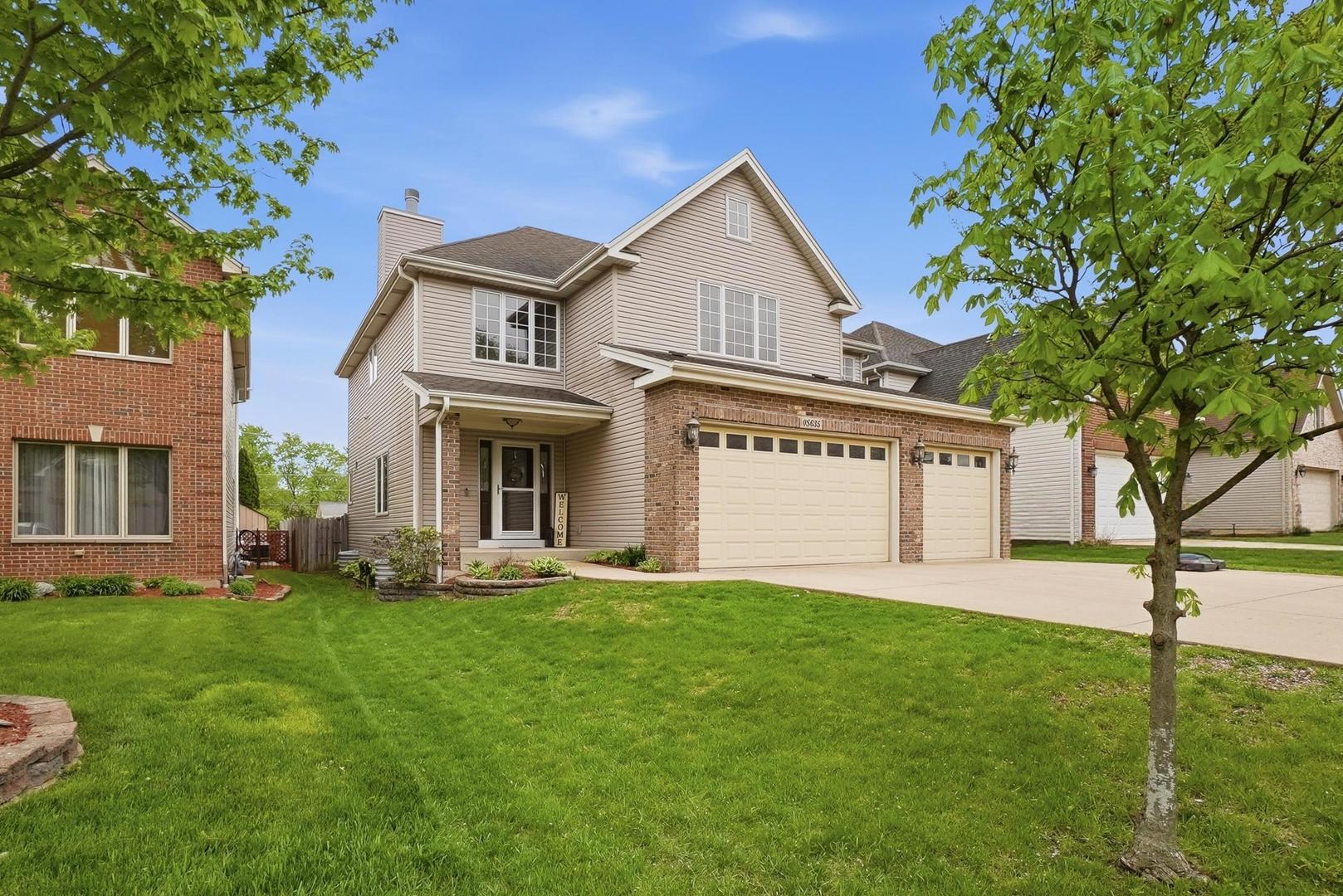 S635 Robbins Street Winfield, IL 60190 - Photo 2 of 35 a front view of a house with a yard and garage