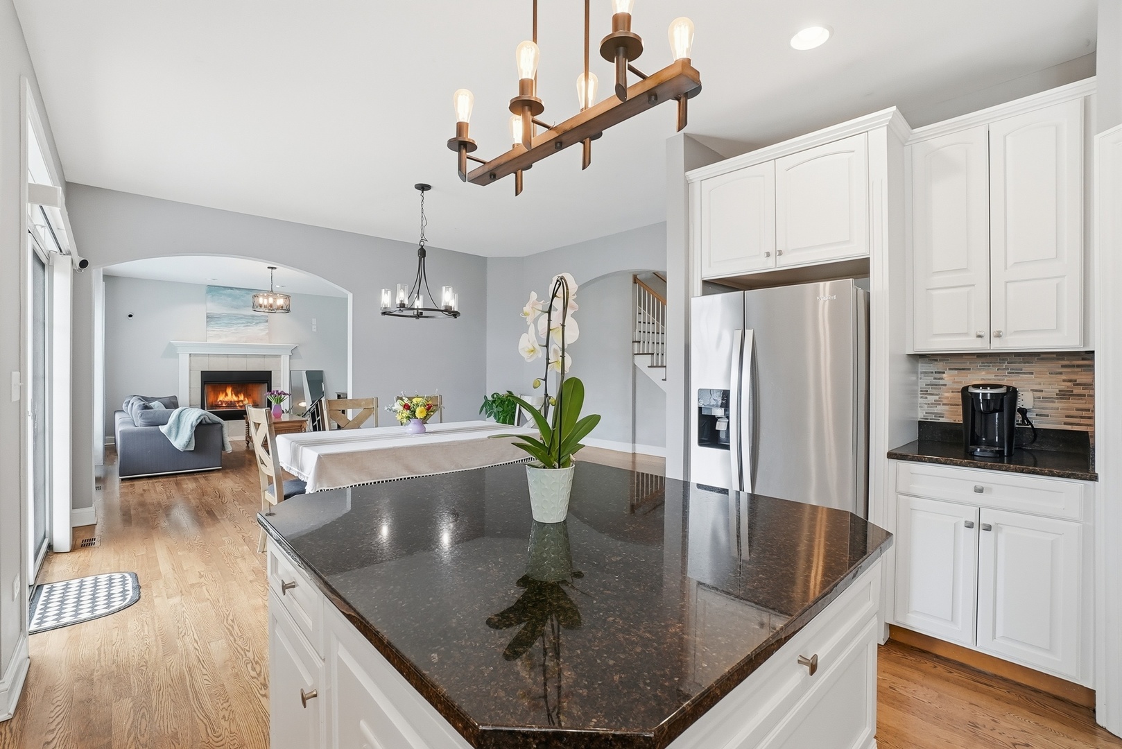S635 Robbins Street Winfield, IL 60190 - Photo 6 of 35 a kitchen with stainless steel appliances granite countertop a refrigerator a stove and white cabinets with wooden floor
